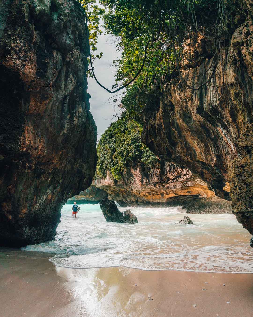 Hidden beach cove between cliffs in Uluwatu, Bali