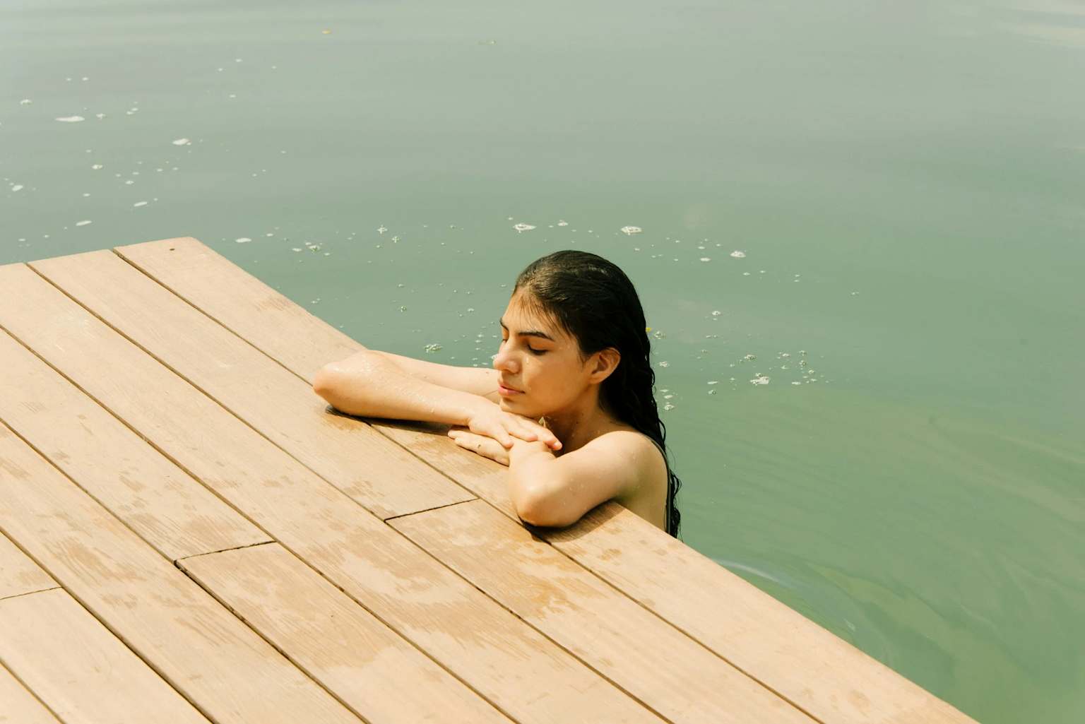 Calm reflective woman by water