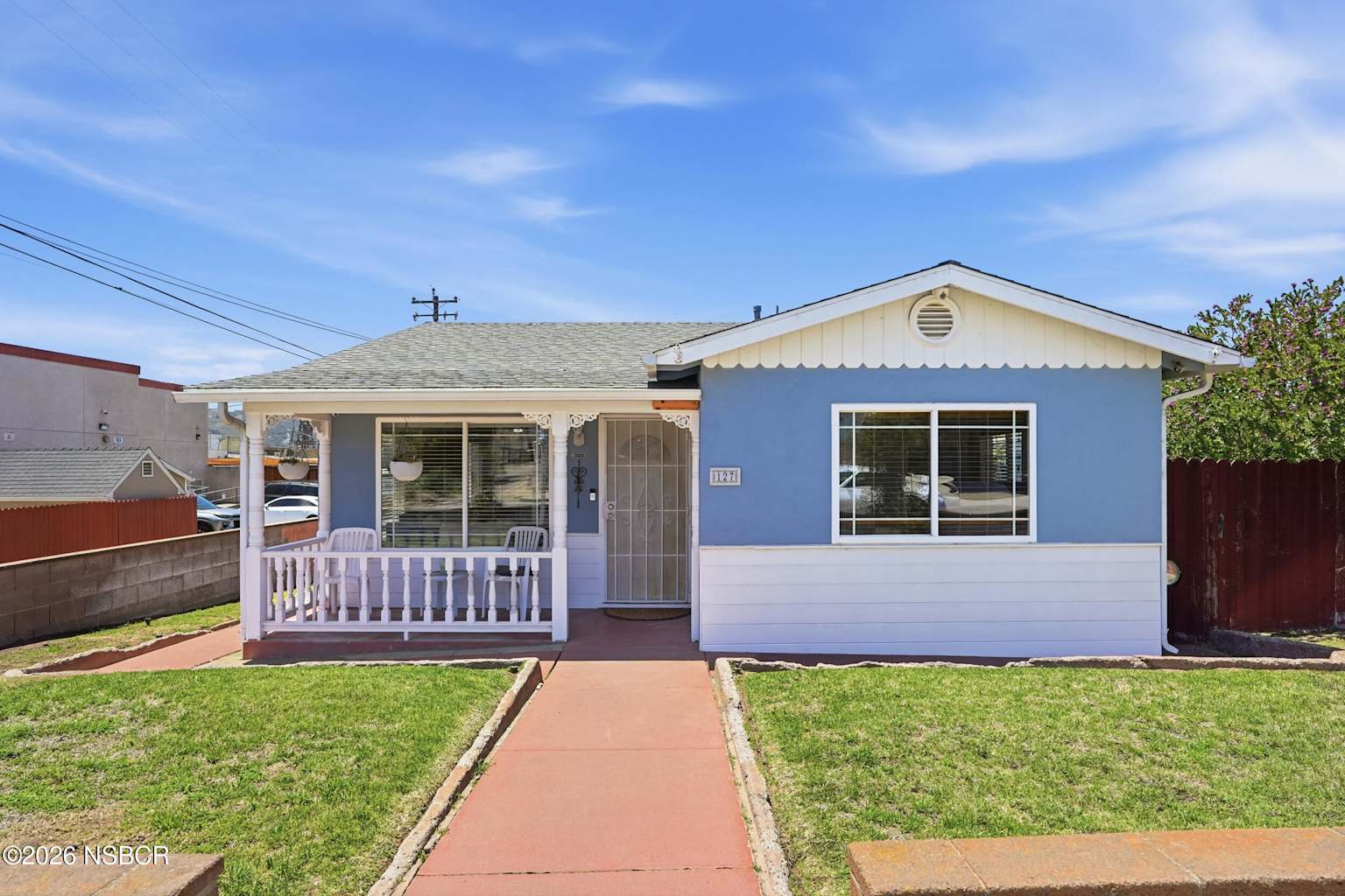 Blue single-story home with front porch on an Orcutt neighborhood street