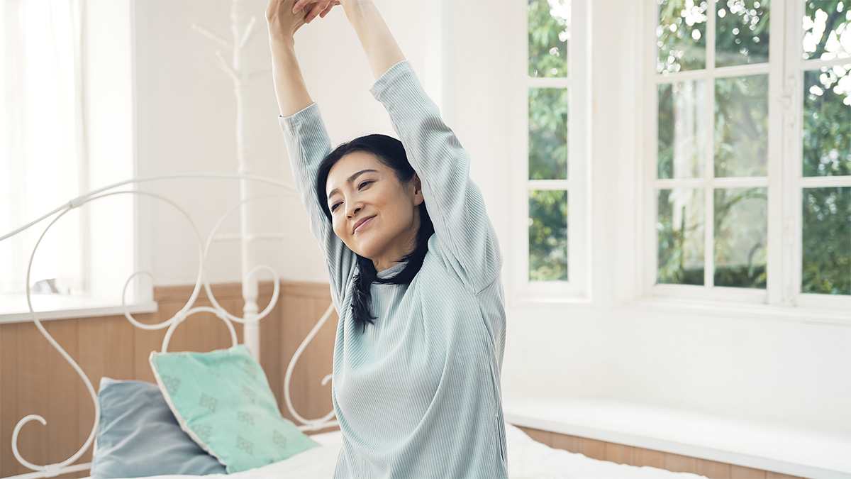 how many hours of sleep — woman waking up refreshed after proper sleep duration