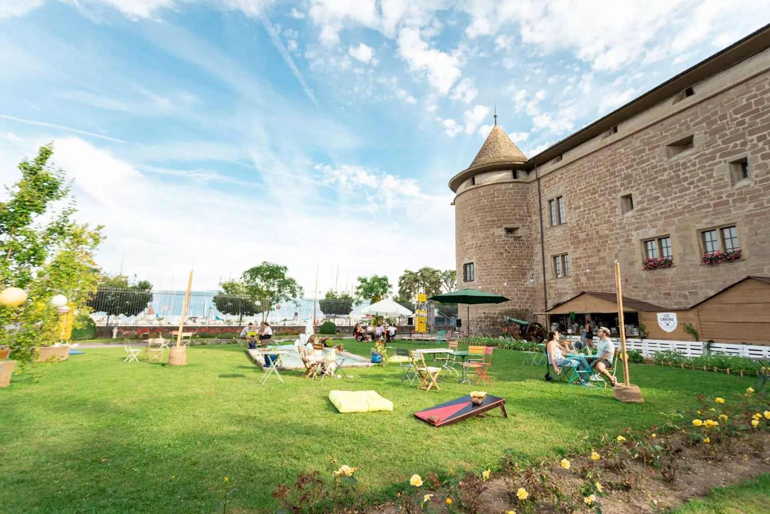 Morges castle lawn people relaxing summer sunny day