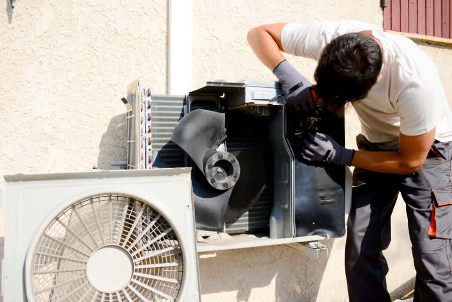Air conditioning unit being serviced