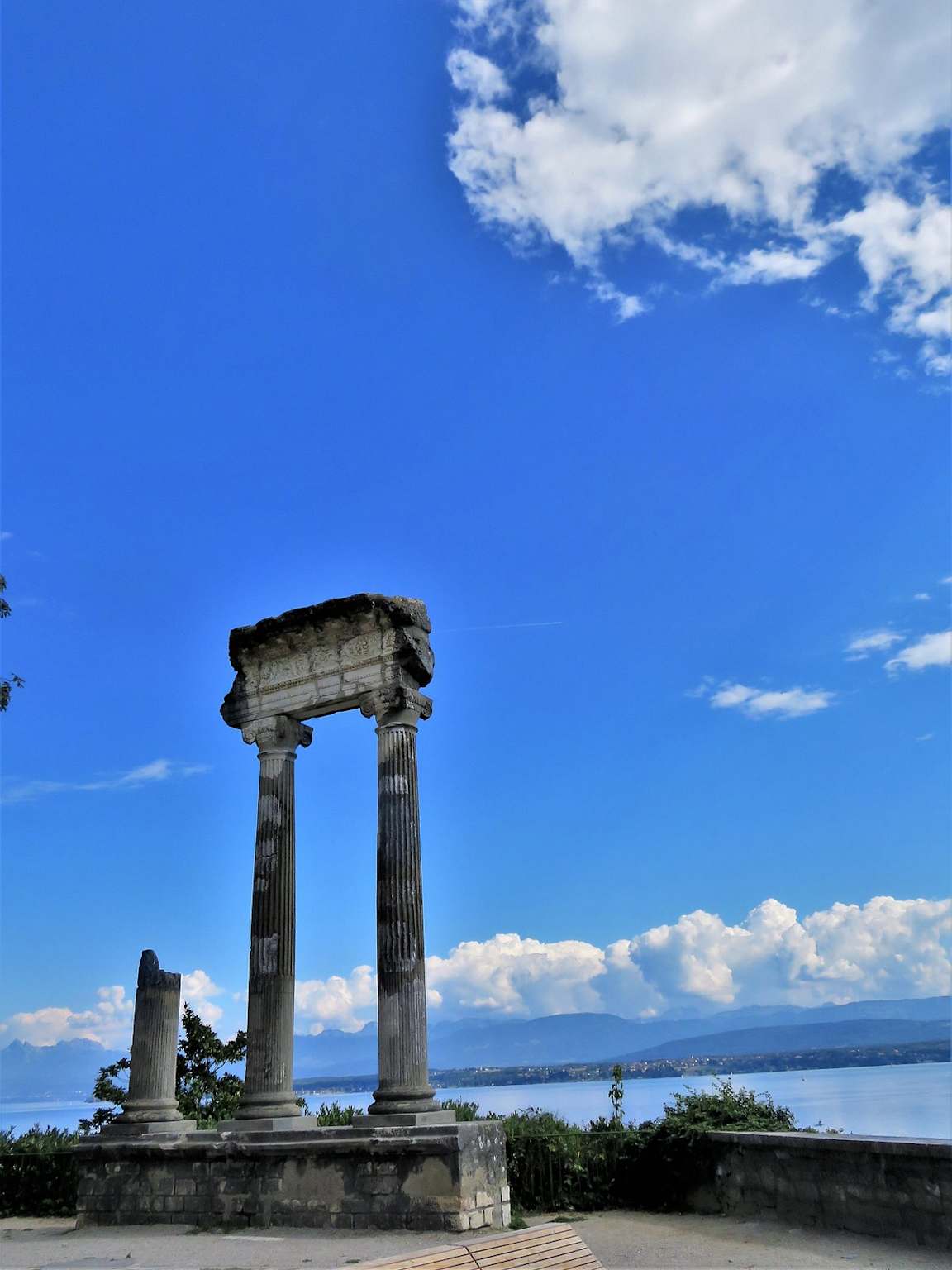 Real Roman columns Nyon lake Geneva Alps background