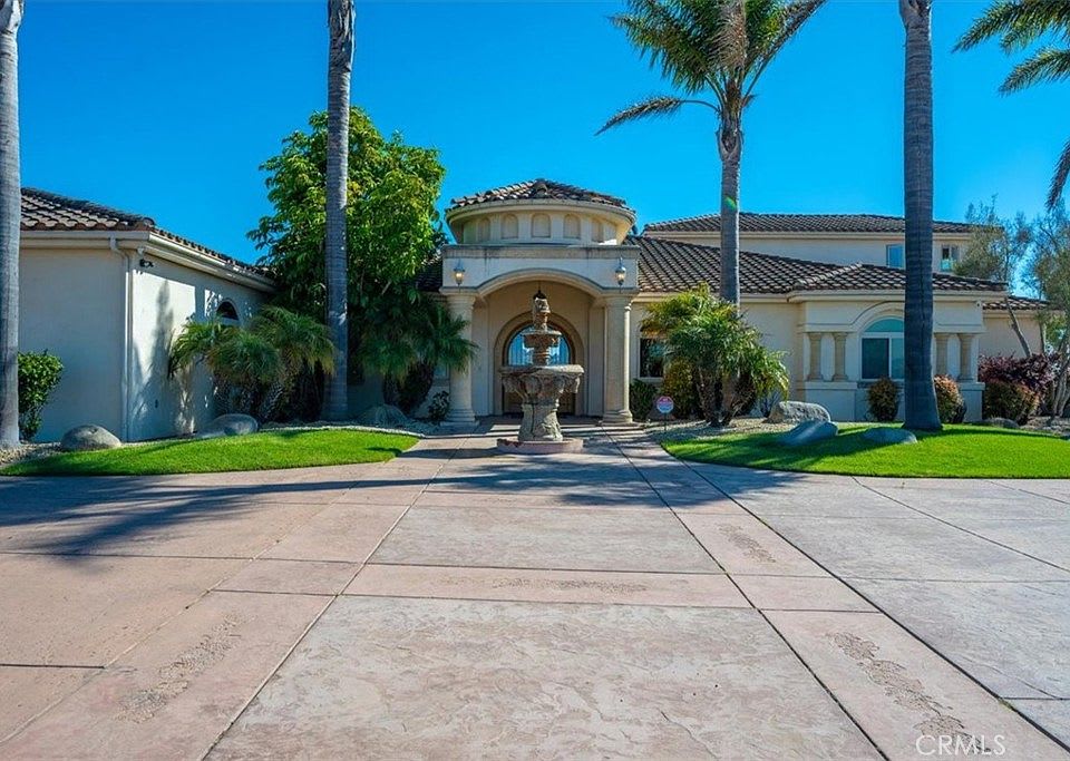 Upscale Nipomo luxury home with driveway, fountain, and strong curb appeal