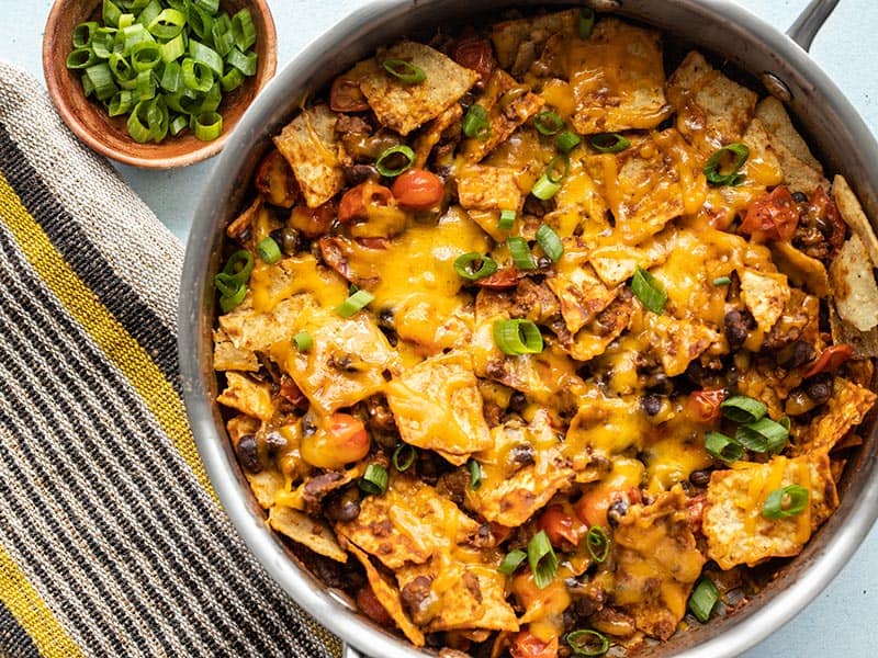 Beef taco skillet with tortilla chips, cheese, and tomatoes