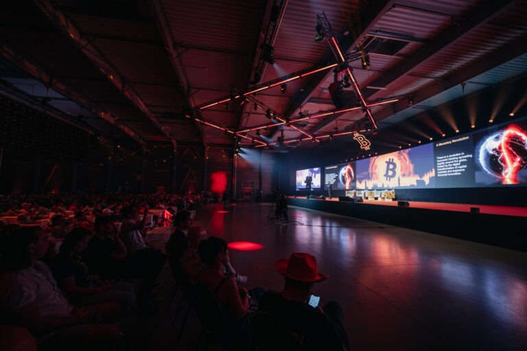 BTCPrague conference crowd auditorium red lighting