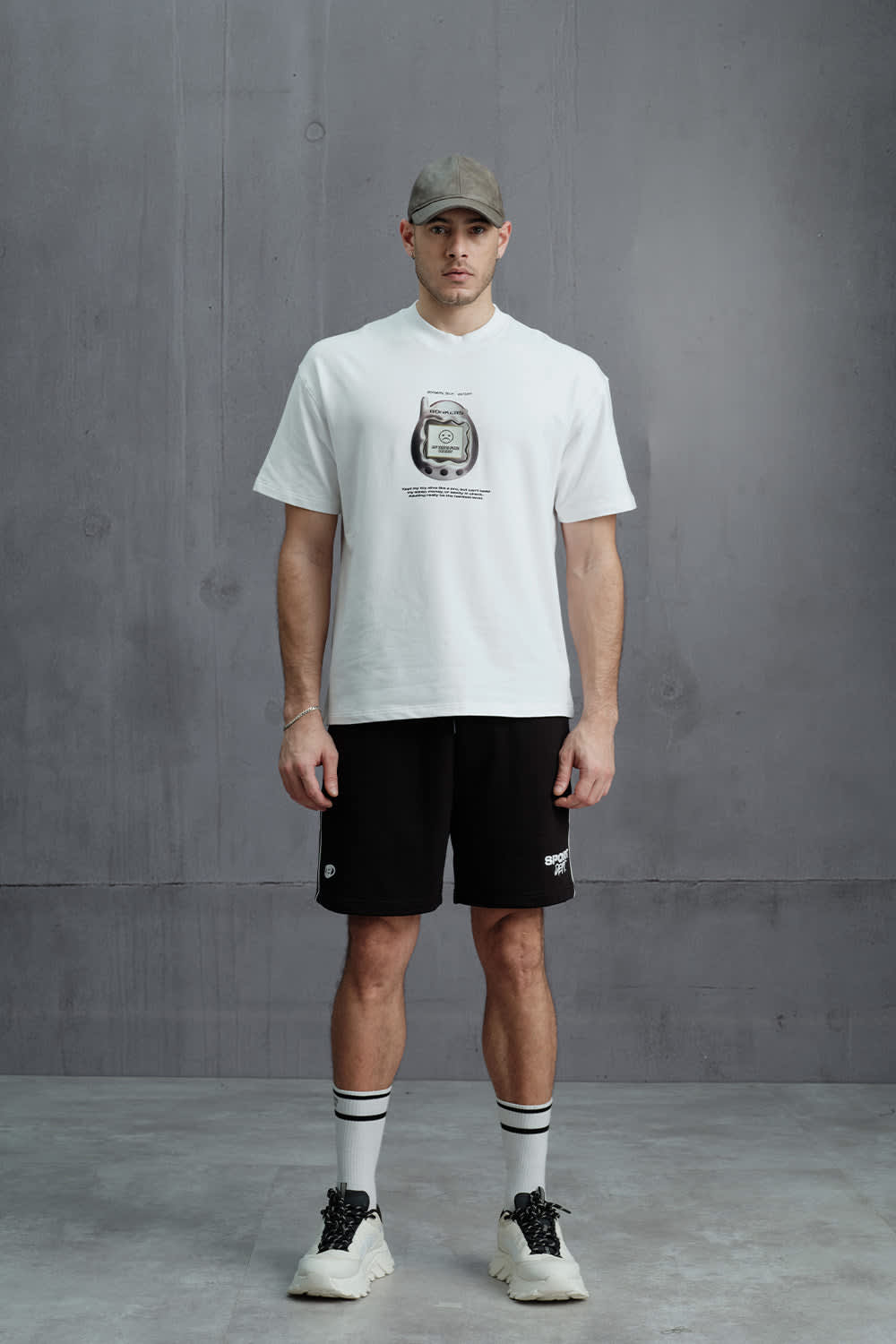 Men airport outfit India — oversized graphic tee with cargo trousers and white sneakers domestic look