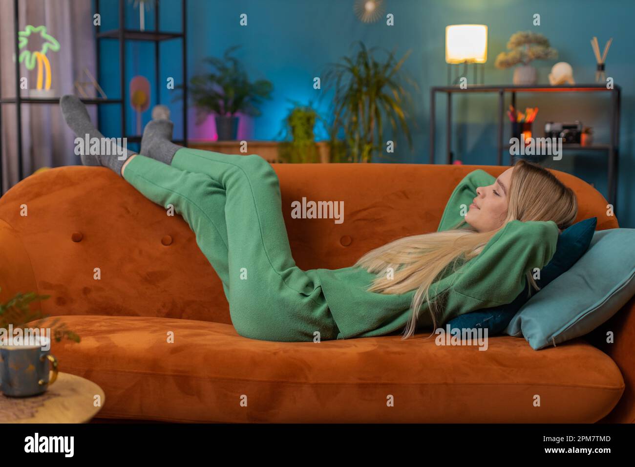 Woman resting on a couch for a daytime nap — timing your nap correctly prevents sleep inertia