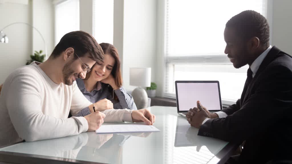 Mortgage consultation scene with a couple meeting a financial advisor