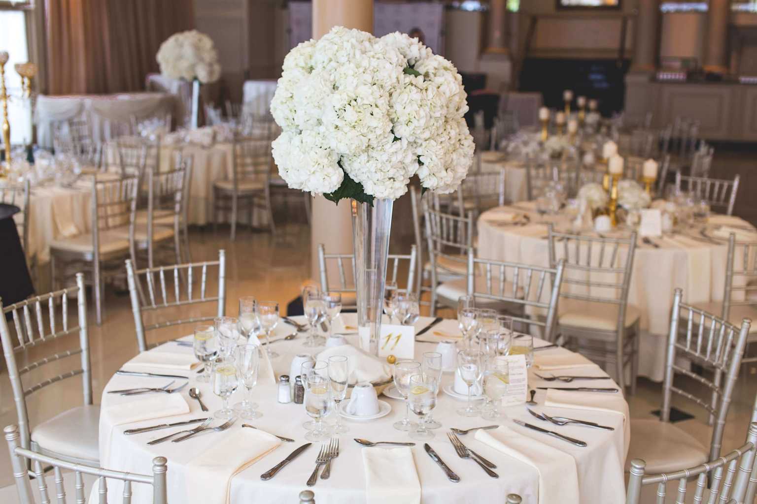 Elegant fundraiser gala venue with round tables and floral centerpieces