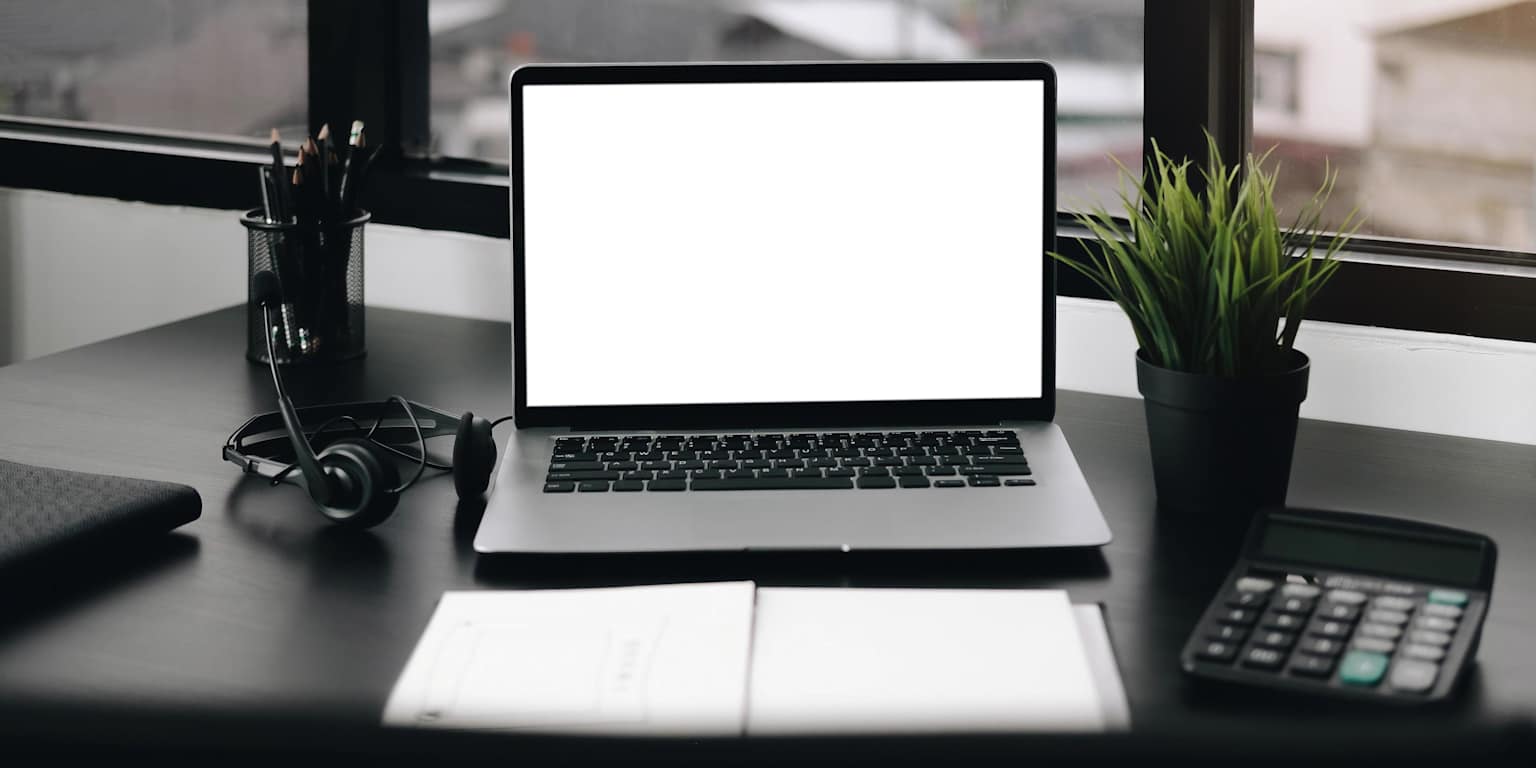 Modern accounting workspace with laptop, calculator and notebook
