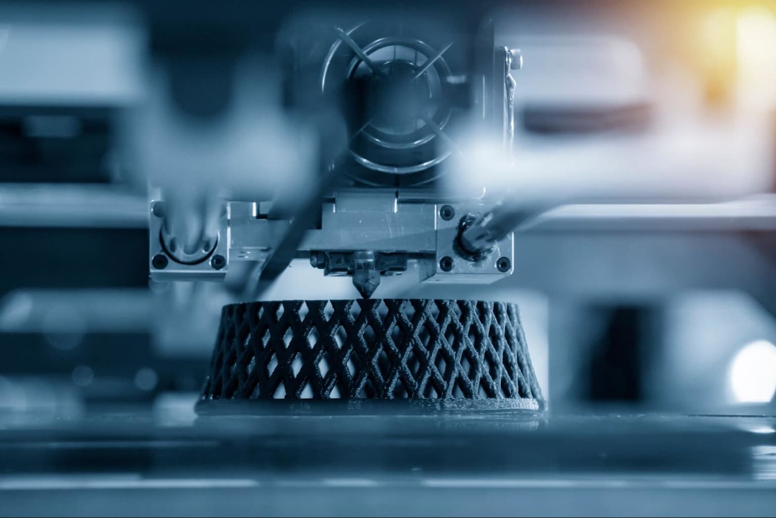 Close-up of a 3D printer creating a lattice prototype