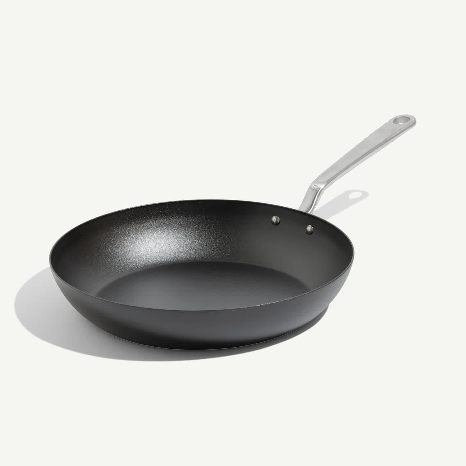 Seasoned black carbon steel frying pan