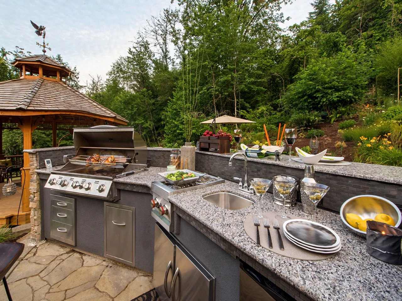 Completed outdoor kitchen with granite countertops and pergola in Bay Area backyard
