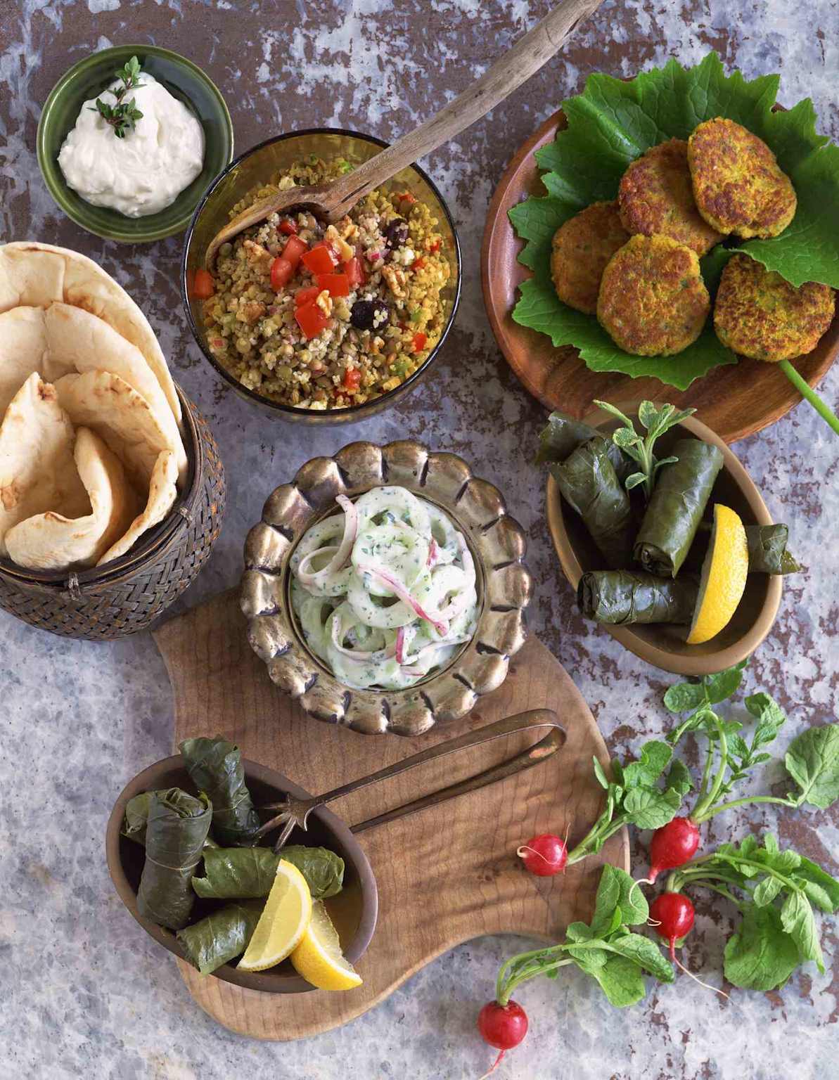 Traditional Greek meze table with pita, dips, and stuffed grape leaves