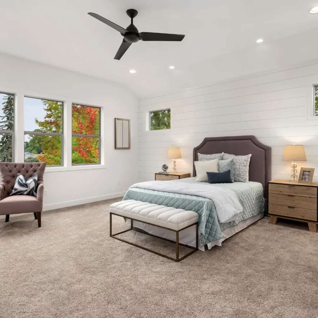 A modern bedroom combining a ceiling fan with air conditioning for energy efficiency