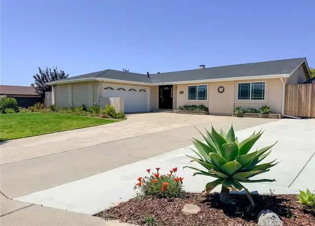 A single-story suburban house with a driveway, garage, and front yard landscaping in Santa Maria, California.