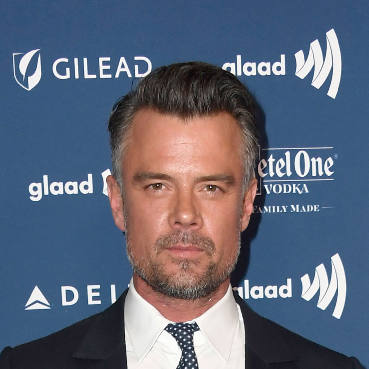 Josh Duhamel with tapered fade and small quiff hairstyle at event