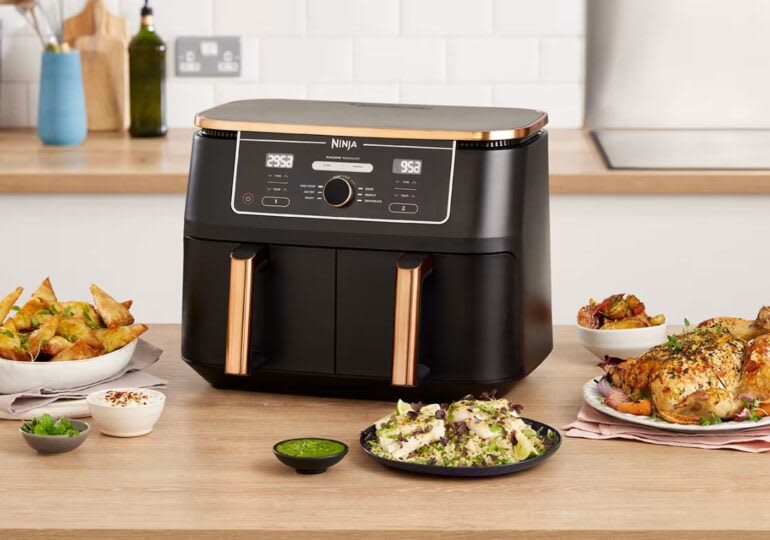Ninja dual basket air fryer with cooked foods on counter
