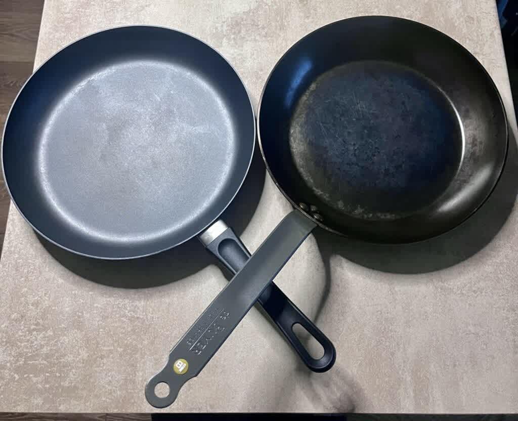 Carbon steel pan next to nonstick pan on kitchen counter