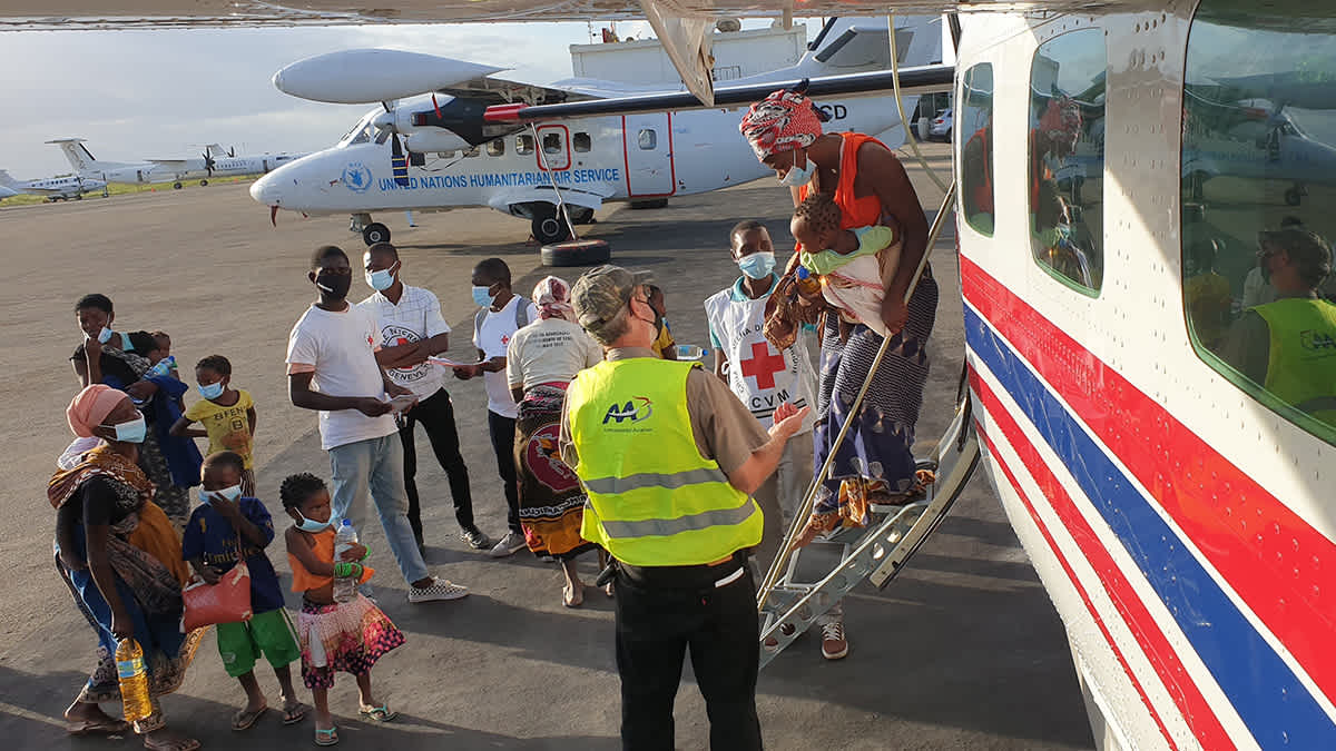 Refugees and NGO workers boarding aircraft in Africa