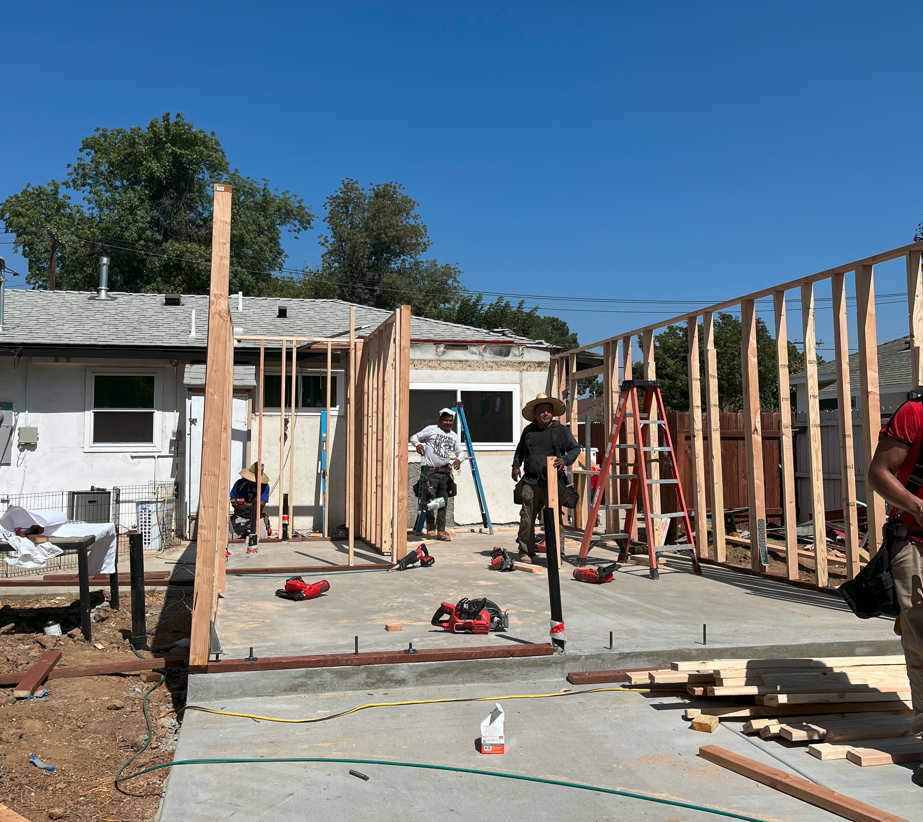 Workers framing a new single-family home on a slab foundation