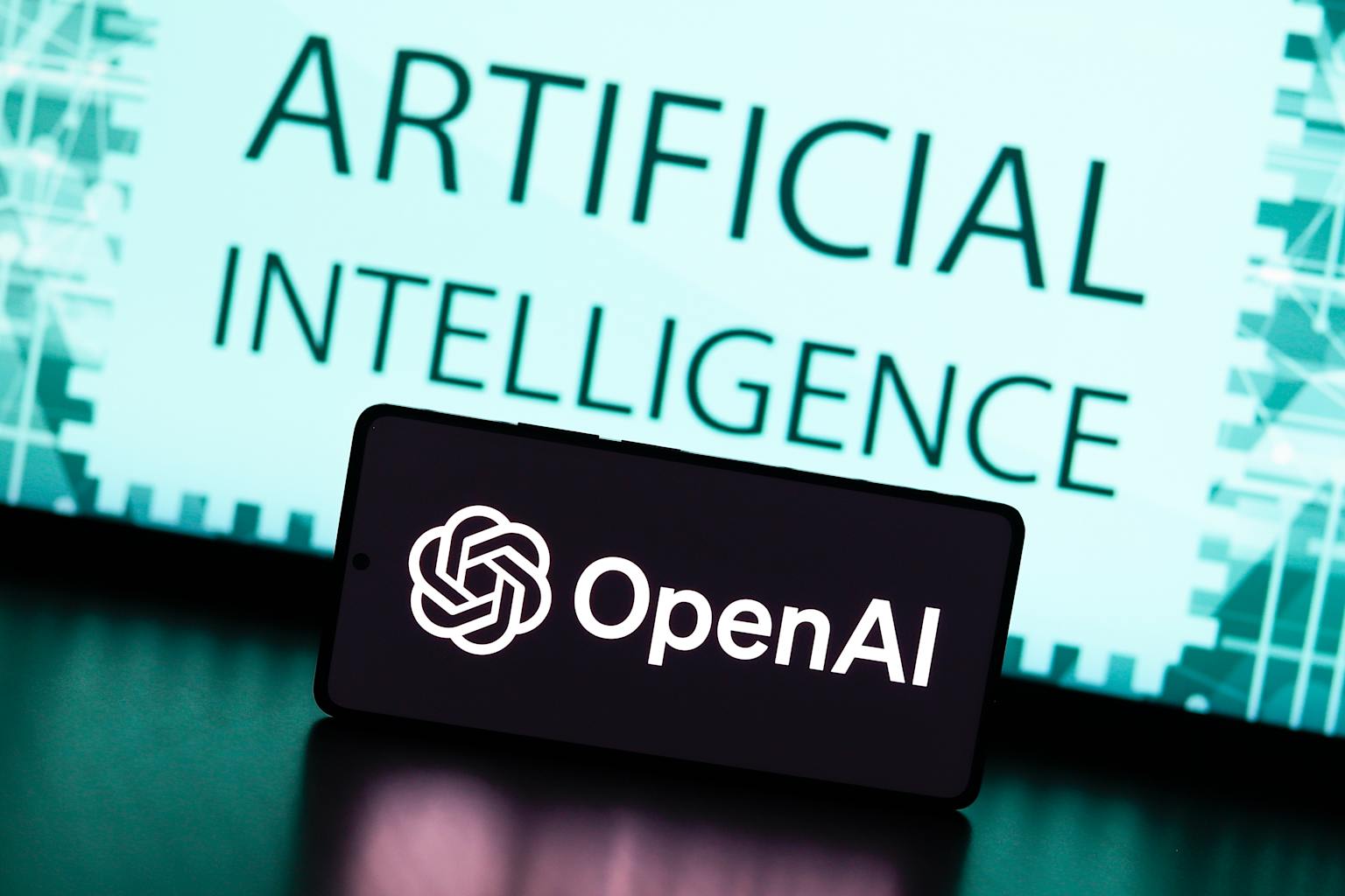 In this photo illustration, the OpenAI logo is displayed on...