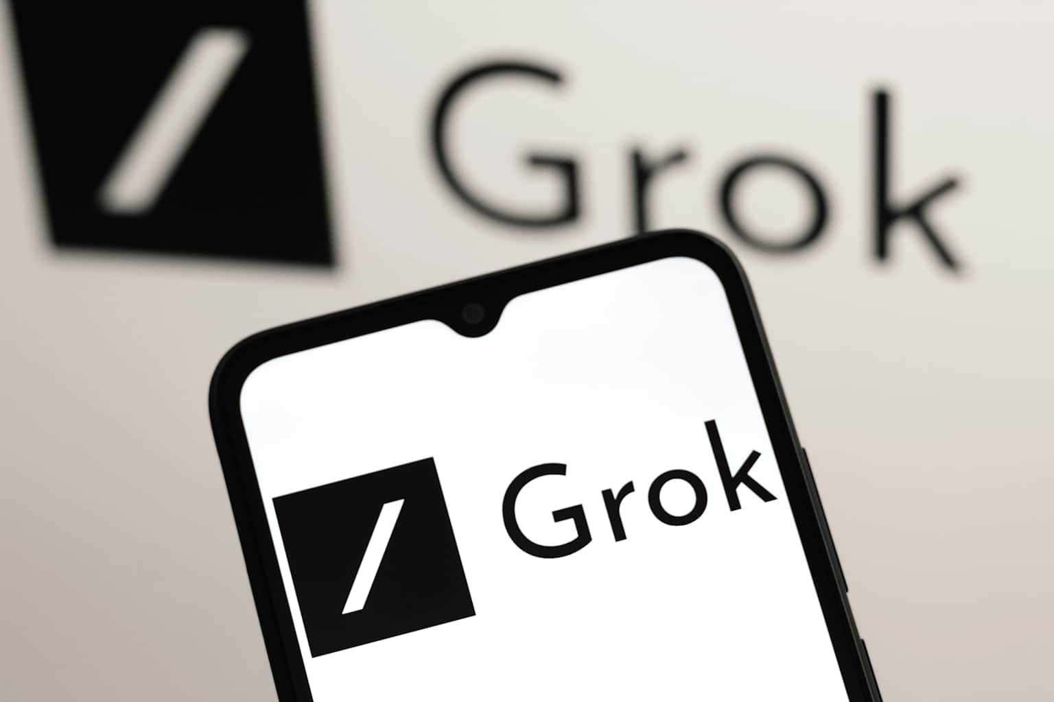 In this photo illustration, the Grok logo is seen displayed...