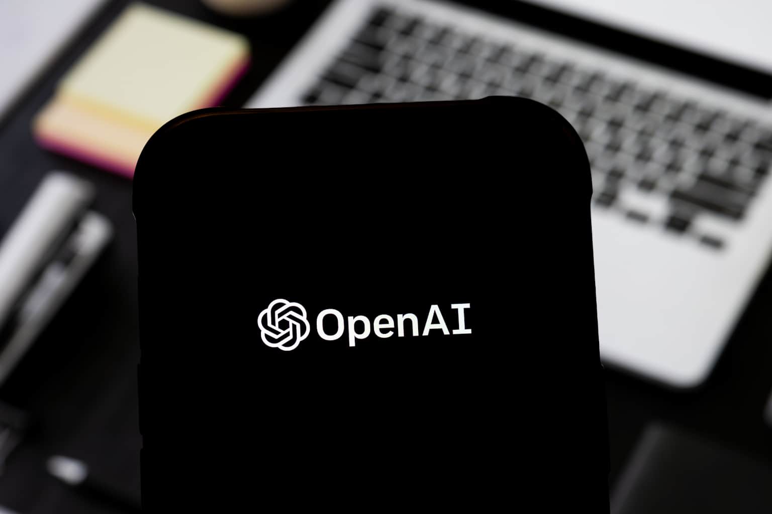 In this photo illustration, an OpenAI logo is seen displayed...