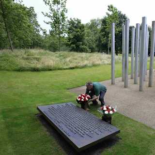 A man places a floral wreath at the 7/7 London Bombings Memorial in Hyde Park, commemorating the victims of the attacks