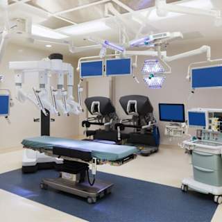 Modern cardiac care unit equipped with advanced robotic surgical systems and multiple monitors