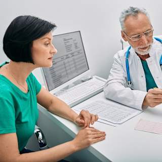 Cardiologist explaining heart anatomy and test results to a patient during consultation