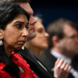 A formal parliamentary session potentially discussing UK migration laws, with key figures blurred for privacy