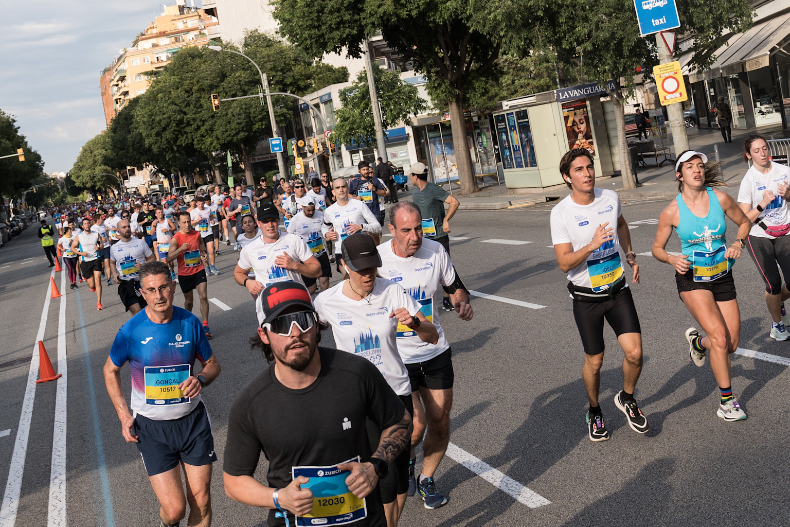 Runners seen on a street of the marathon route next to the...