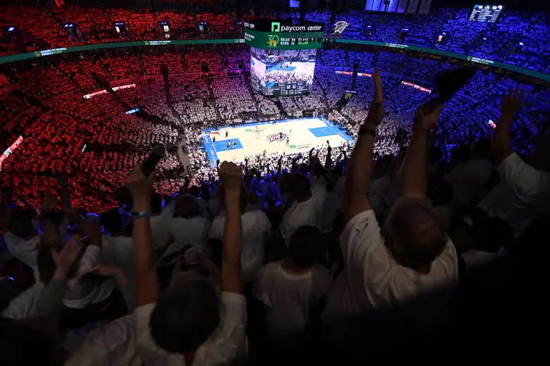 A packed Paycom Center crowd cheers during a high-stakes basketball game, illustrating the intense atmosphere of a championship series Game 7