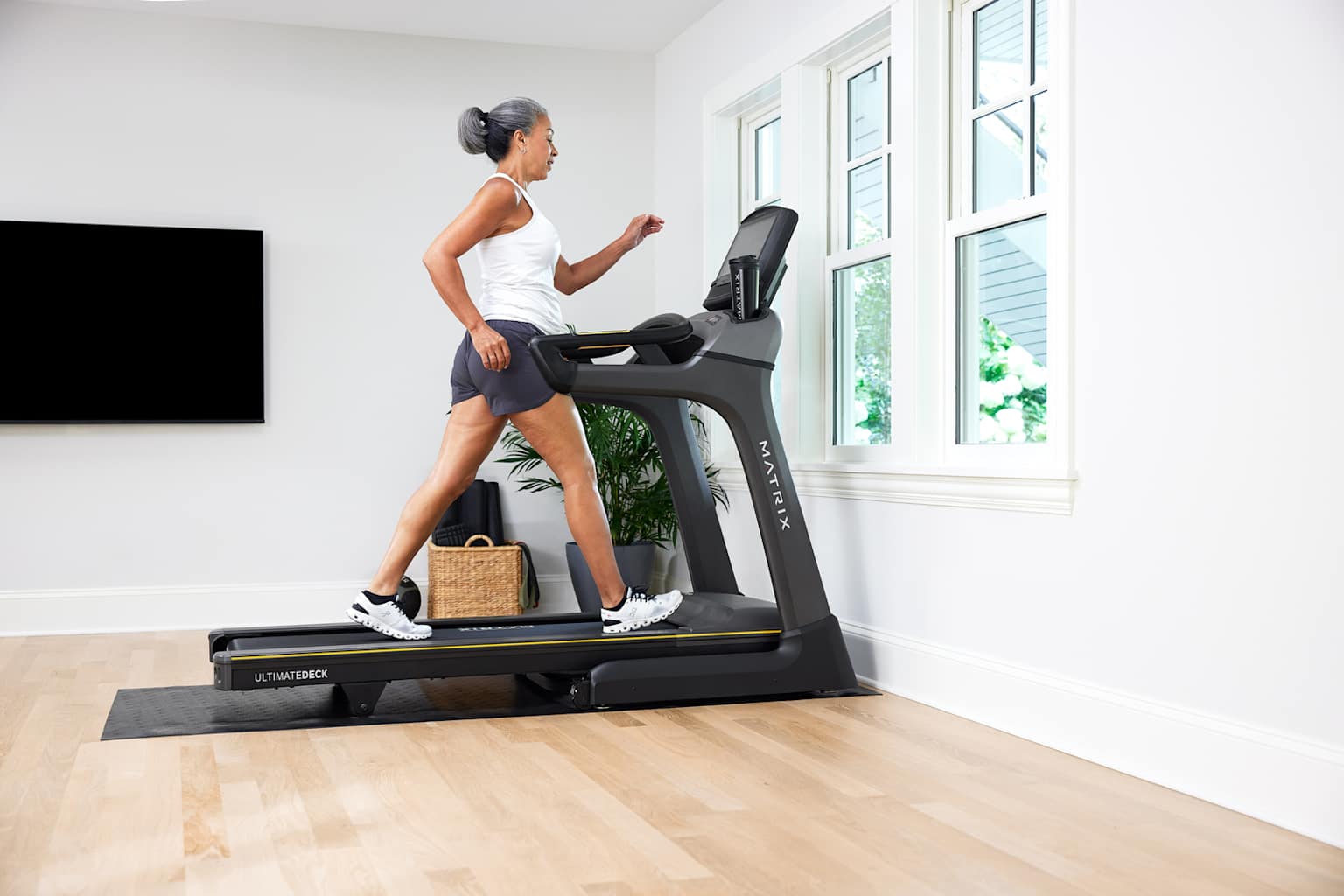 A woman uses a treadmill for exercise.