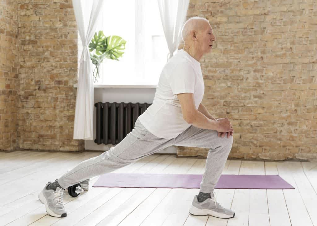 Elderly man doing lunges for functional fitness.