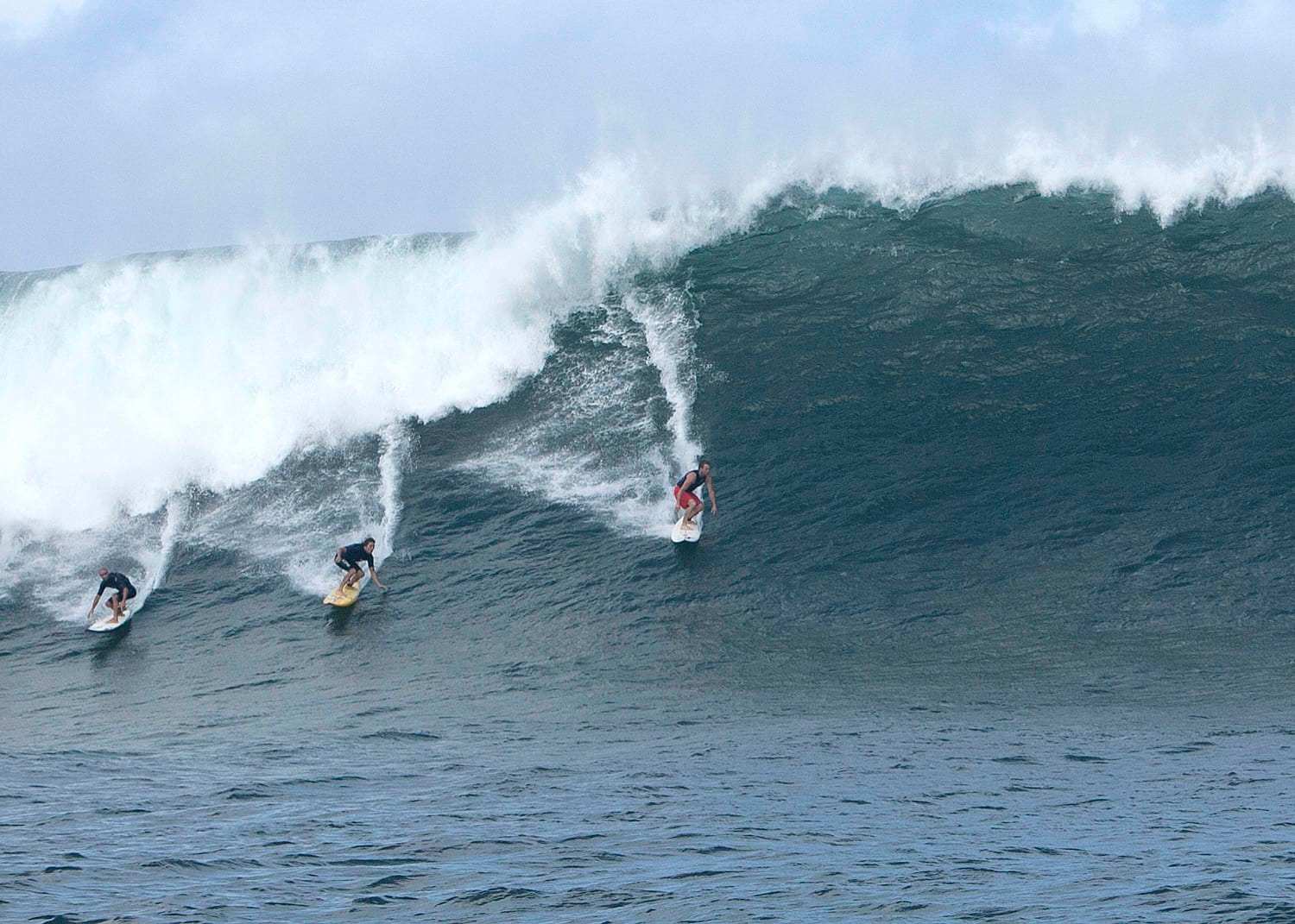 Surfers Ride a Large Wave on Oahu's North Shore