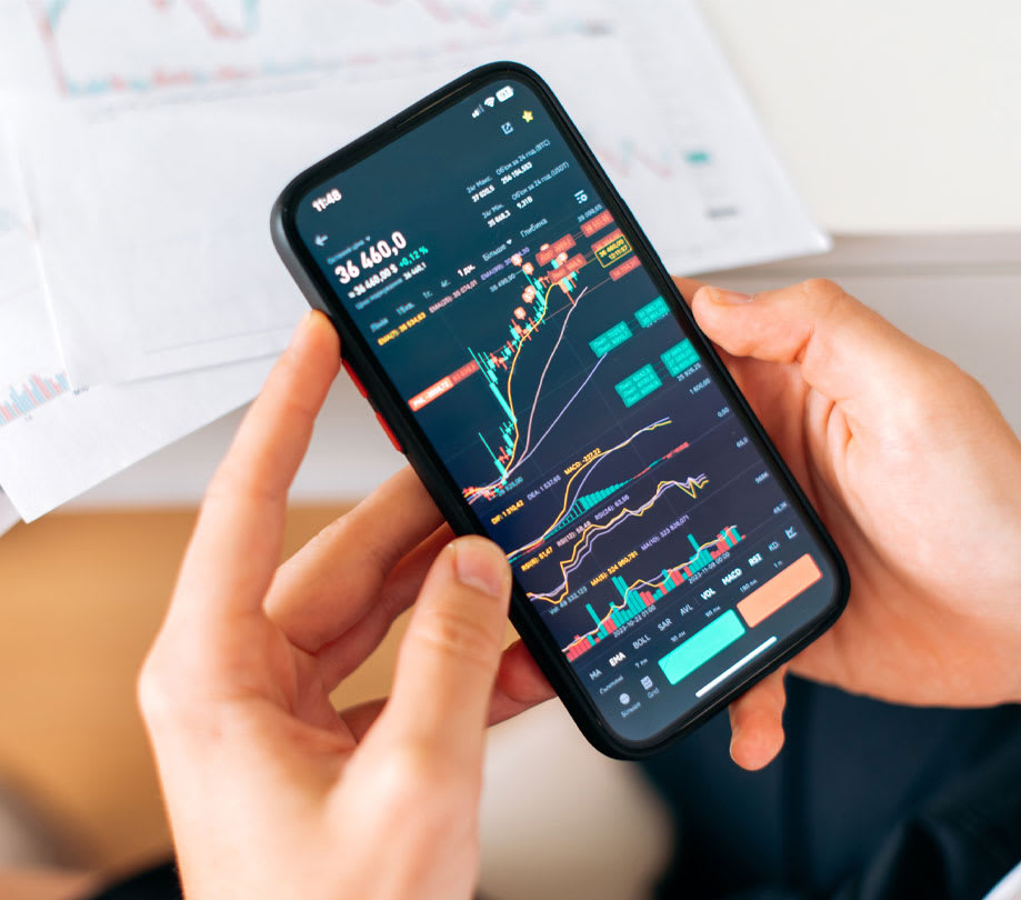 A person engaging with real-time financial market data on a mobile trading application