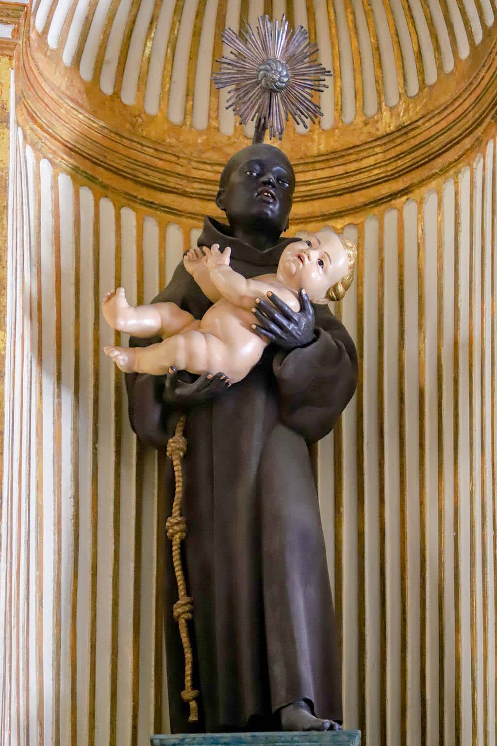 Statue of St. Benedict the Moor holding the baby Jesus