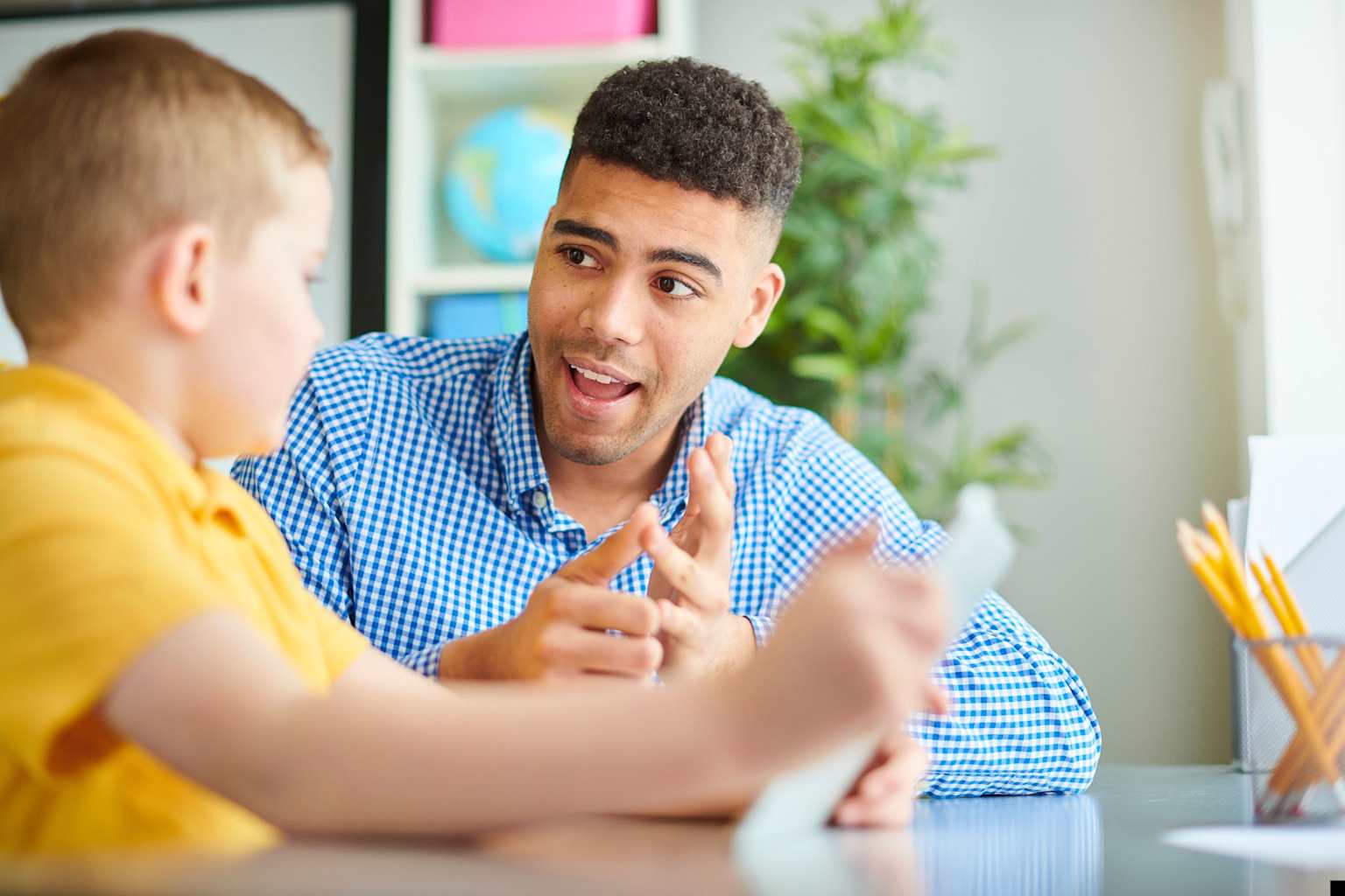 A tutor helps a young student with learning