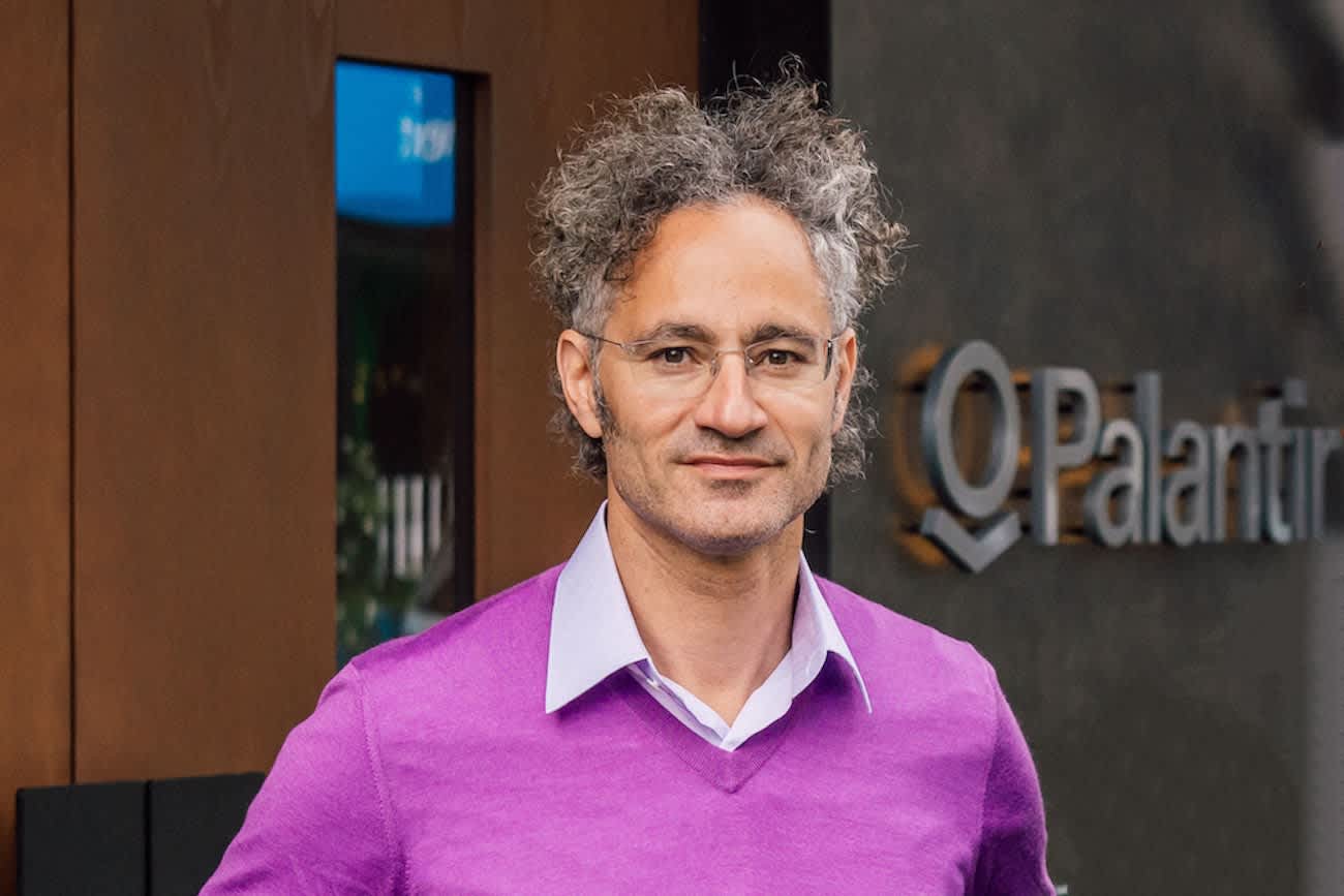 Alex Karp, CEO of Palantir Technologies, in front of the company sign