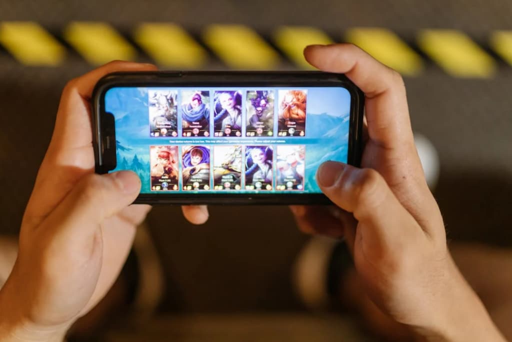 A person engaging in mobile gaming on a smartphone, showcasing a character selection screen.