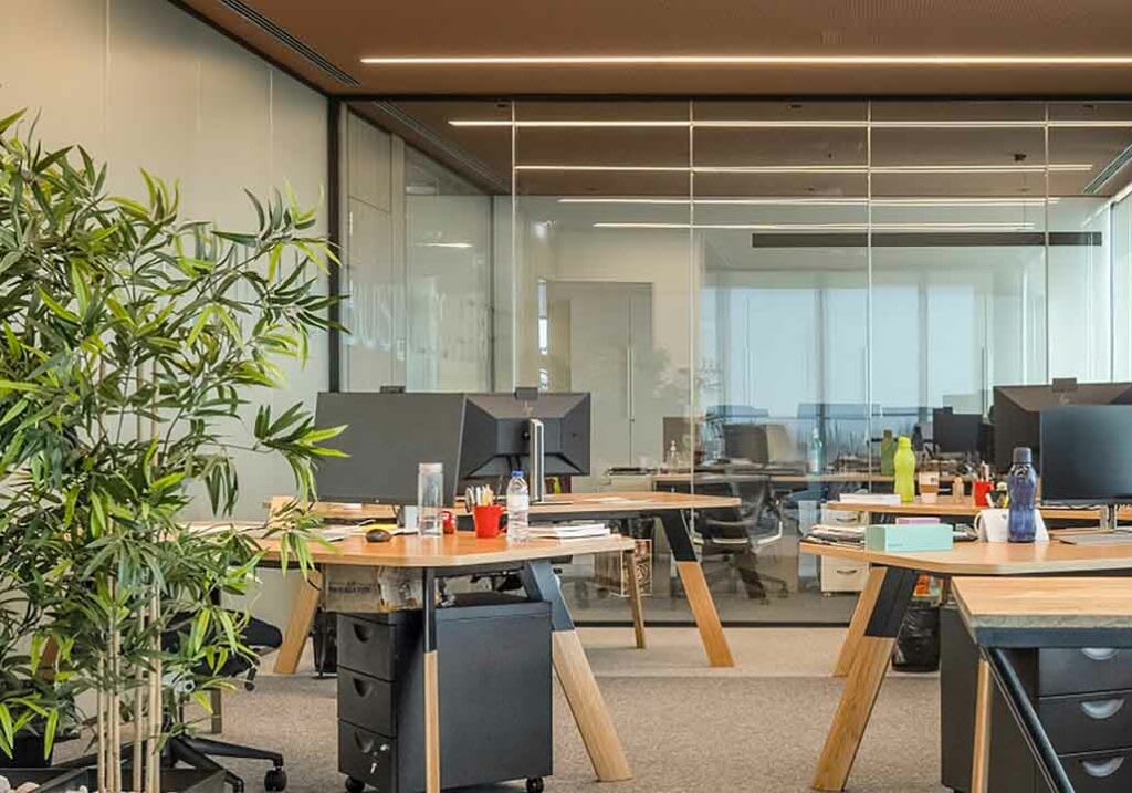 Modern open-plan office space in Portugal with workstations set up for financial professionals