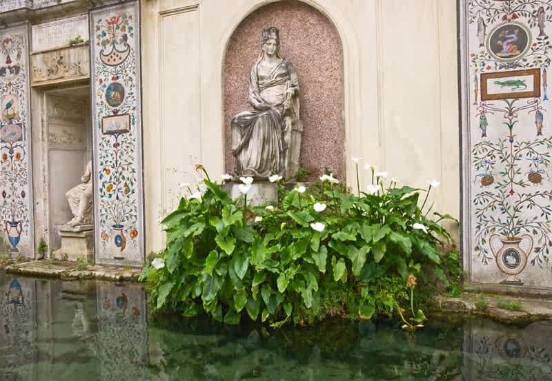A Quiet corner in the Vatican Gardens featuring classical statues and mosaics
