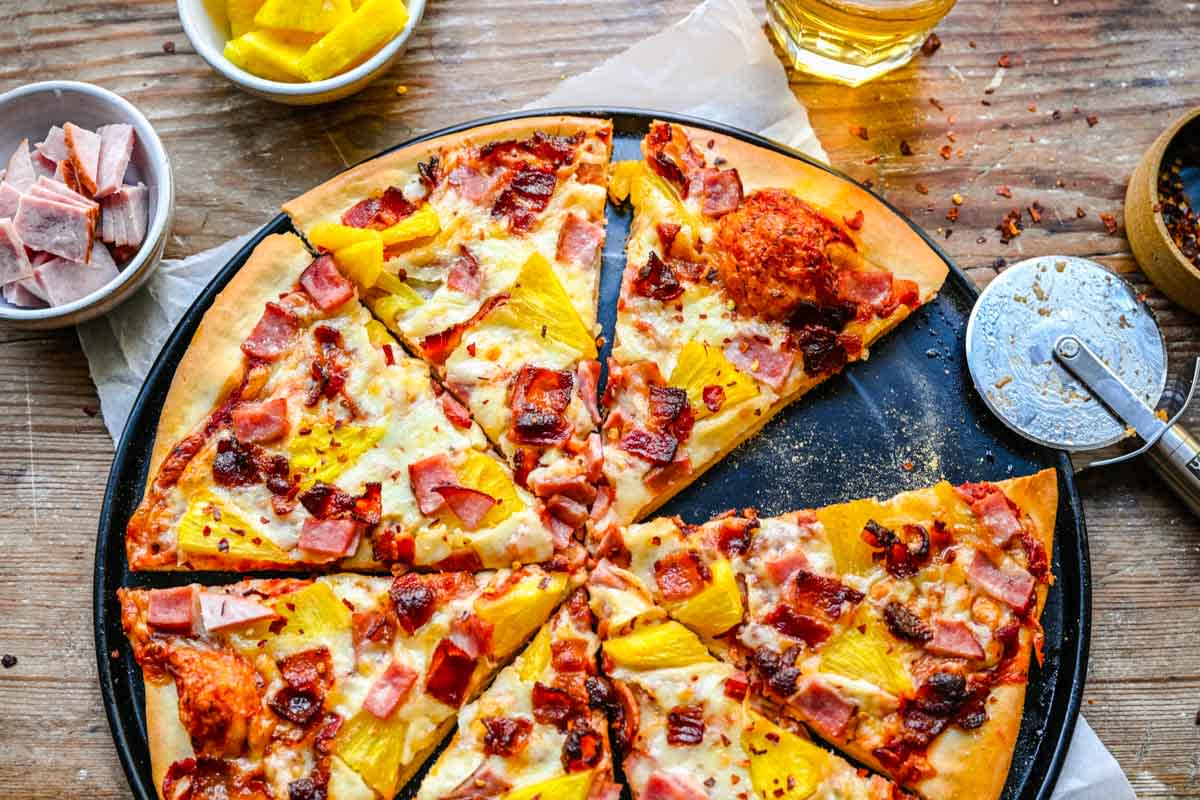 A Hawaiian Pizza with Pineapple and Ham Toppings