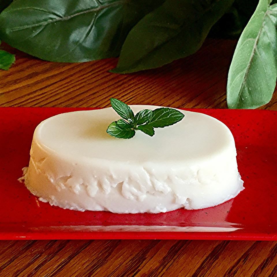 A serving of haupia, a Hawaiian coconut pudding, with a mint garnish