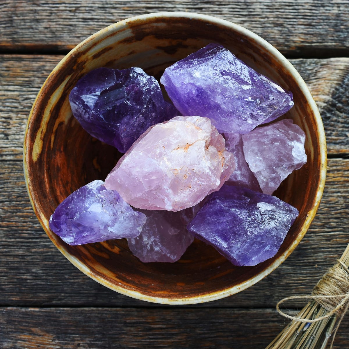 Amethyst and rose quartz crystals in a ceramic bowl