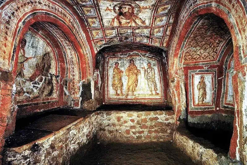 Interior view of a chamber in the Catacombs of San Callisto, featuring ancient Christian frescoes