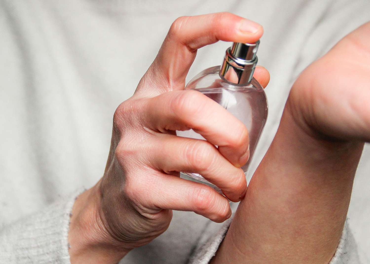 Spraying perfume on the wrist